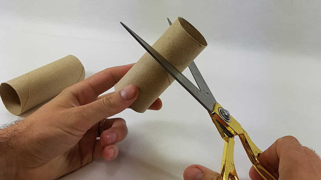 Cutting one of the toilet rolls
